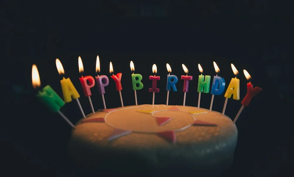 A birthday cake lit with candles